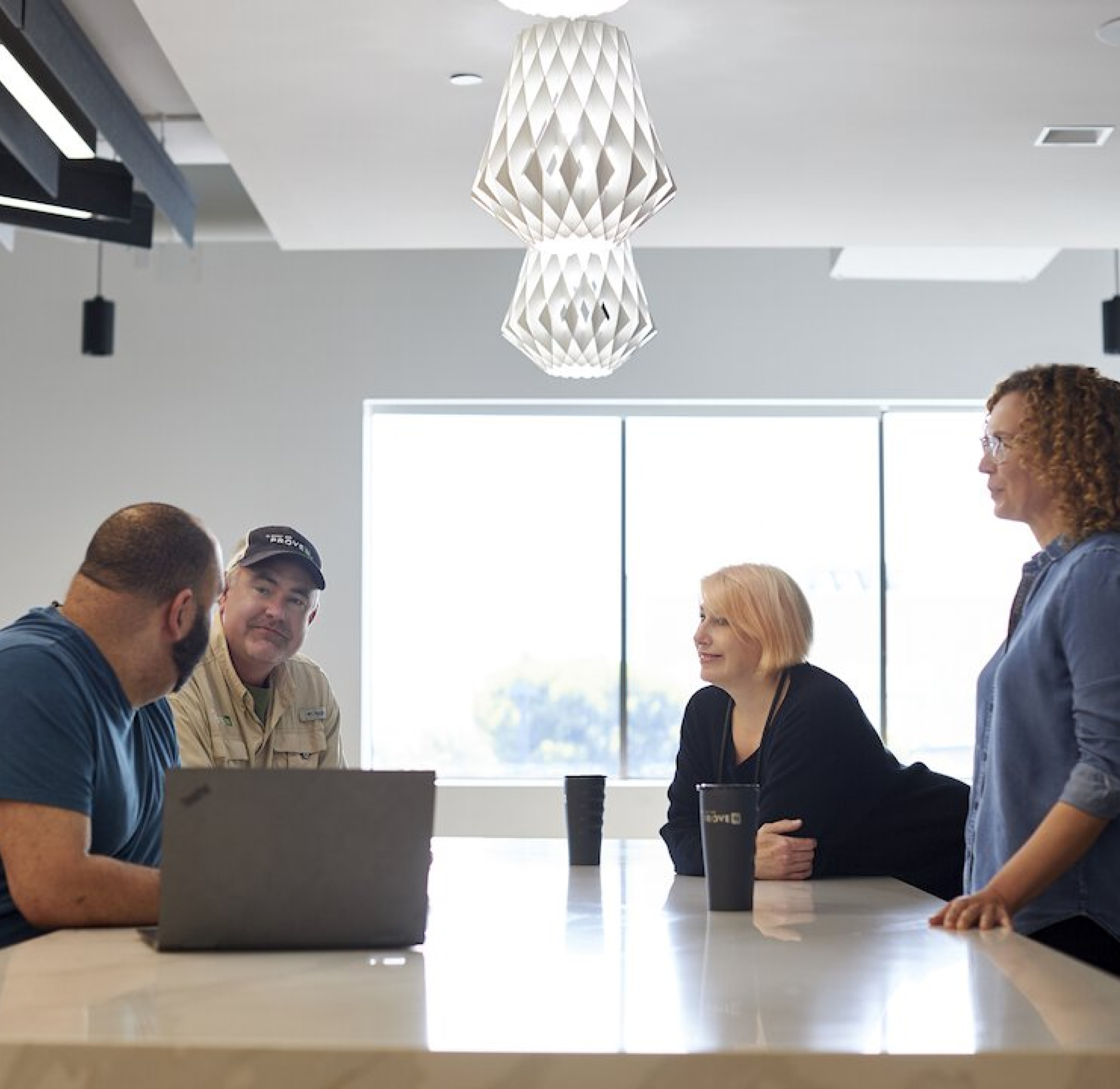 Four Pivot Bio Employees Talking Around a Conference Table