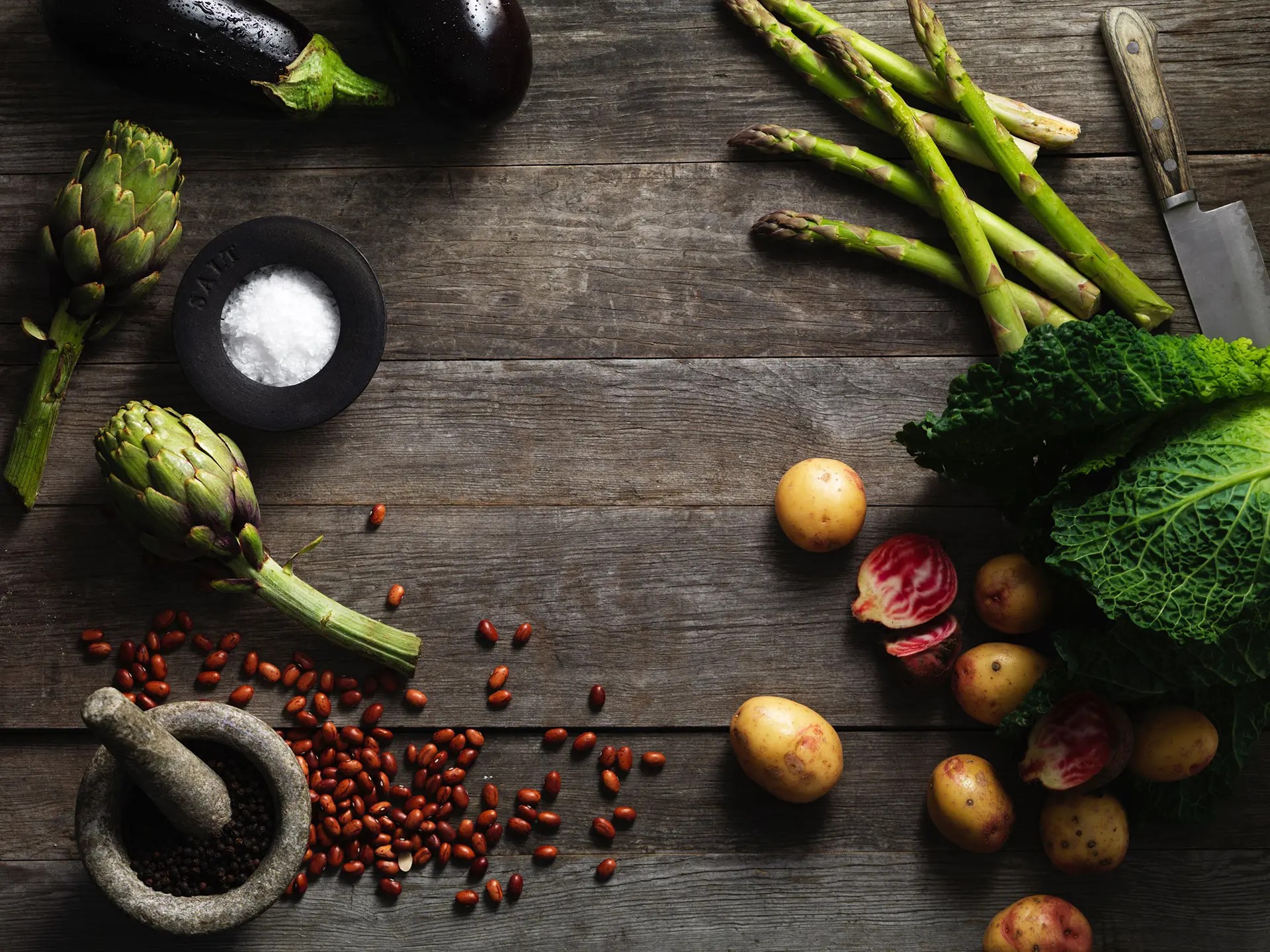 Grönsaker och potatis smakfullt upplagda på träyta