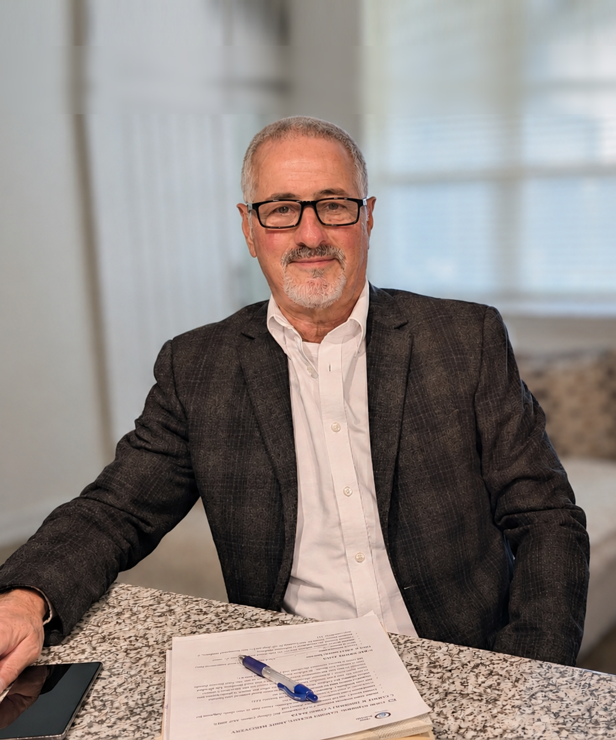 Patrick M. Maley of 360 South, seated at a table reviewing claim paperwork