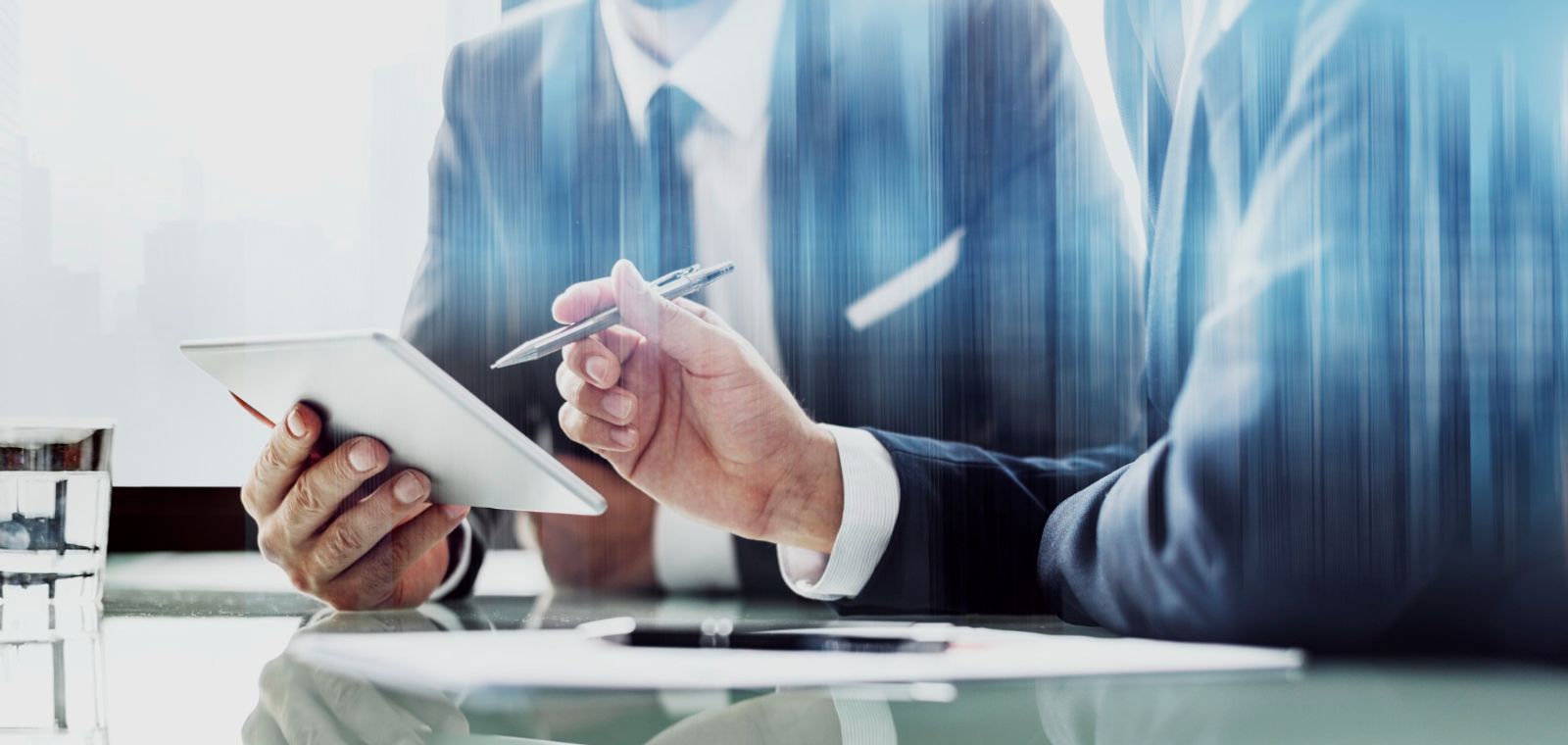Advisor reviewing paperwork on a tablet