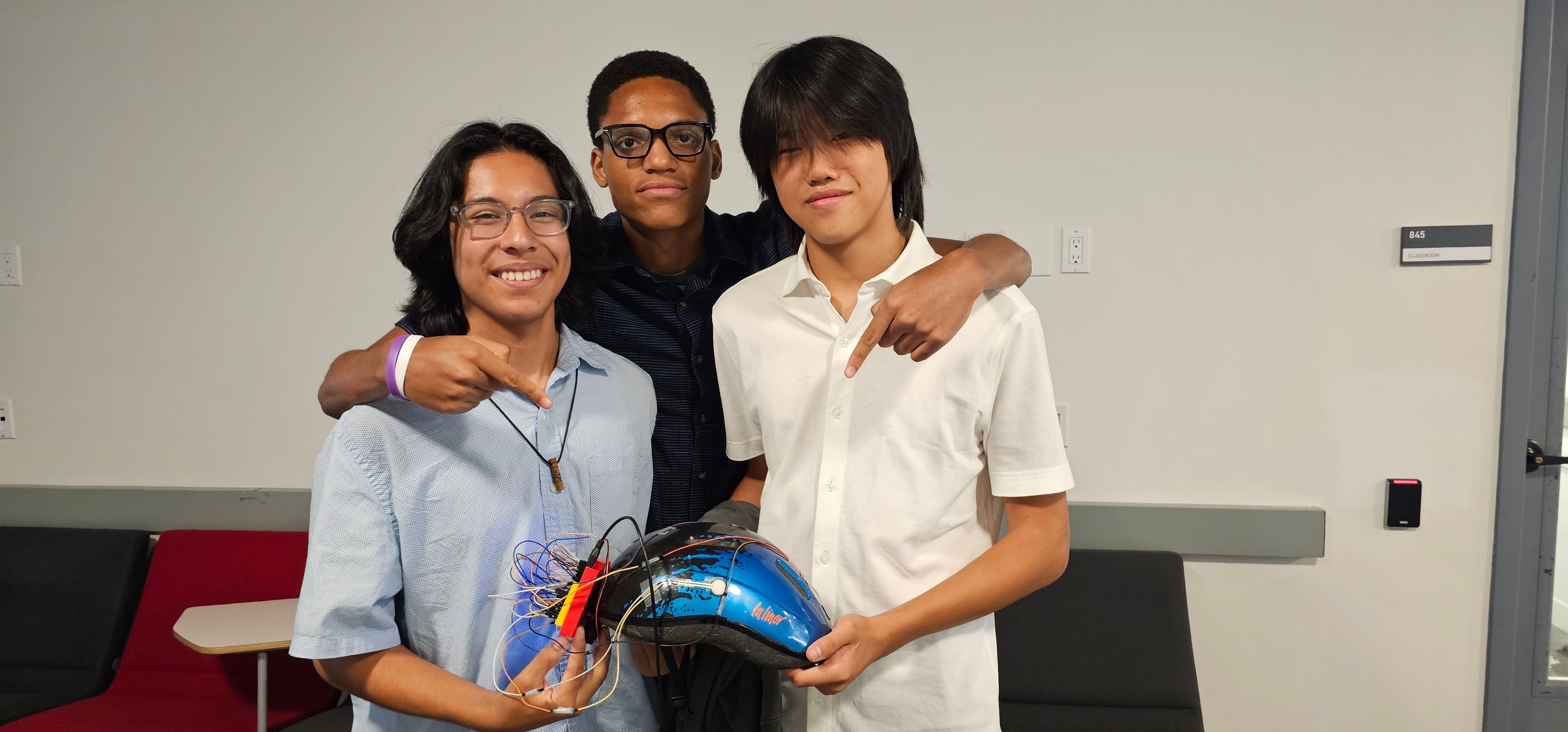 Group of 3 students showing off their final project