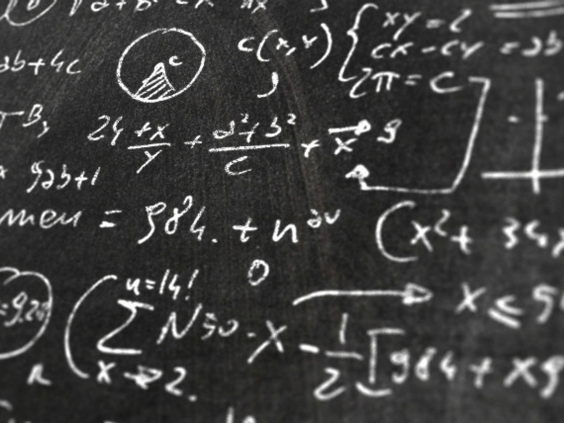 blackboard image with mathematical equations on it