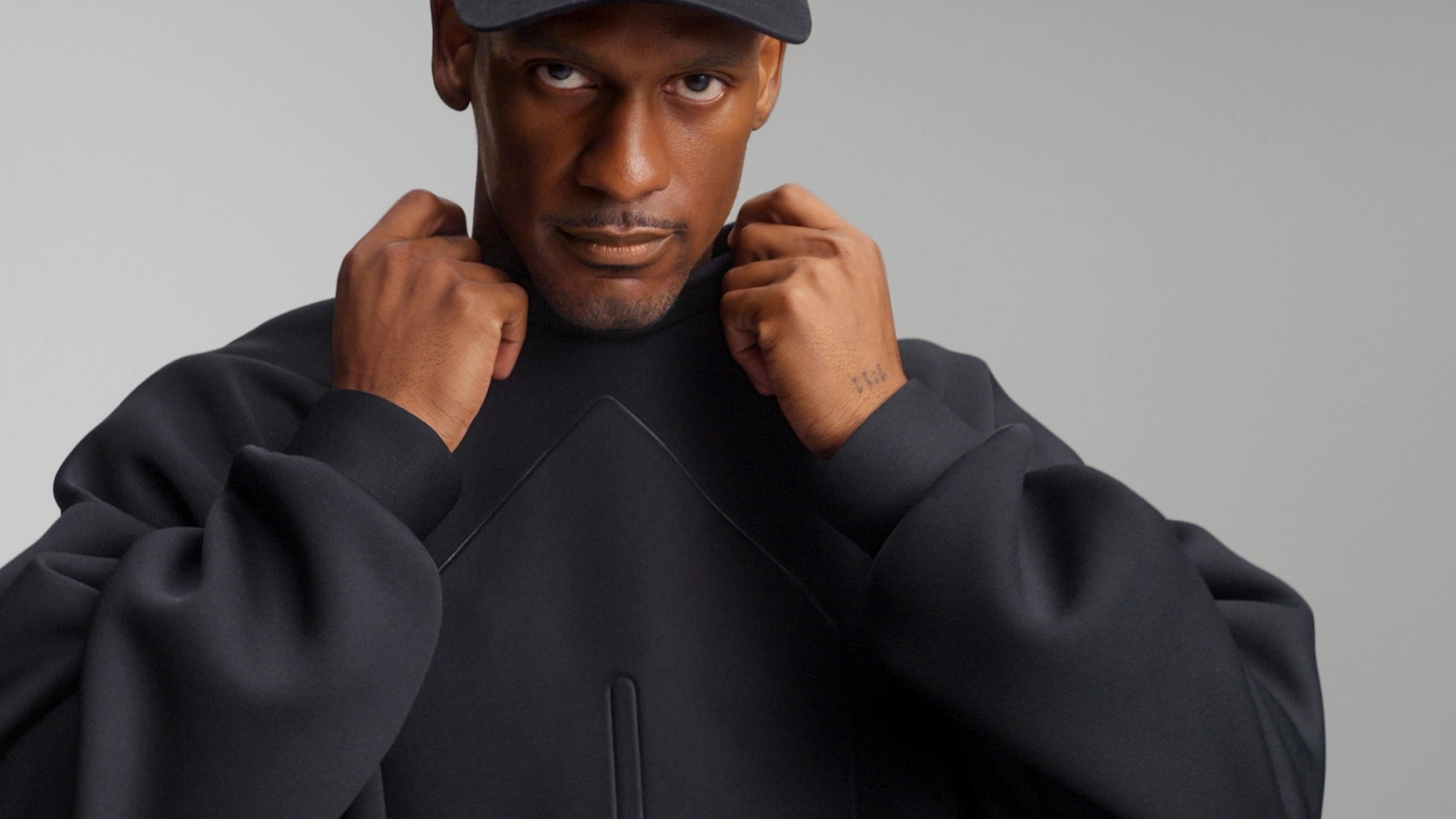 Close up of the oversized sleeve of Glenwood's Signature Crewneck in Black