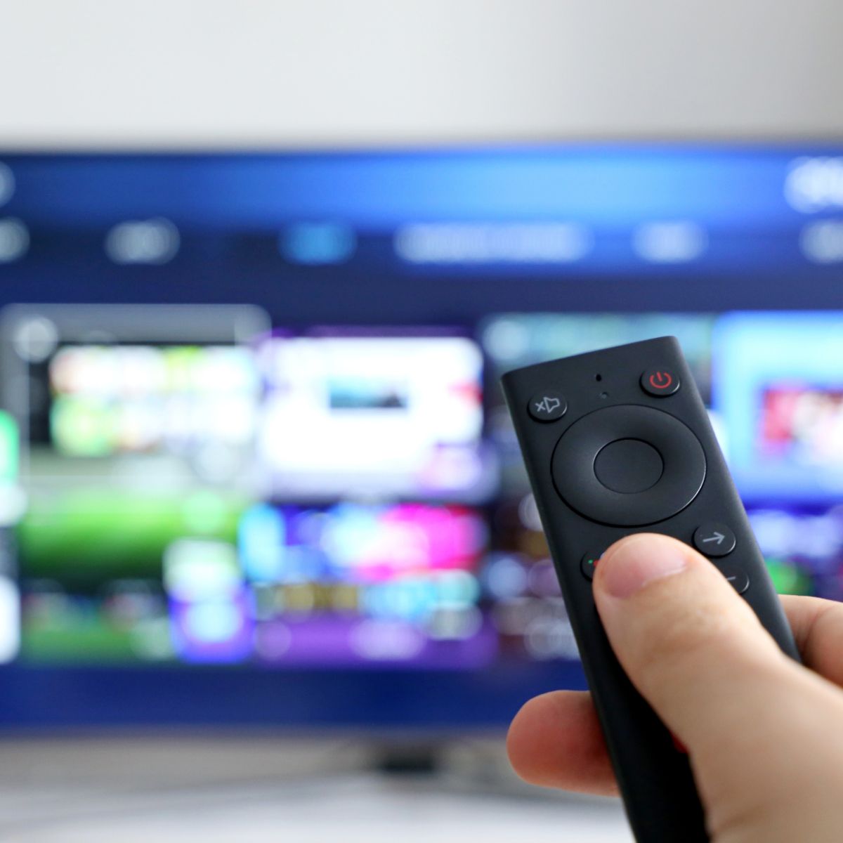 Hand holding streaming TV remote