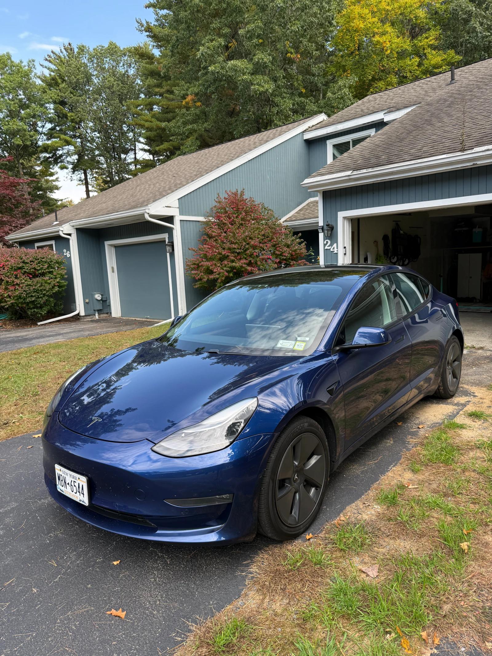 Blue Tesla Model 3 from the front driver's side after paint correction and ceramic coating