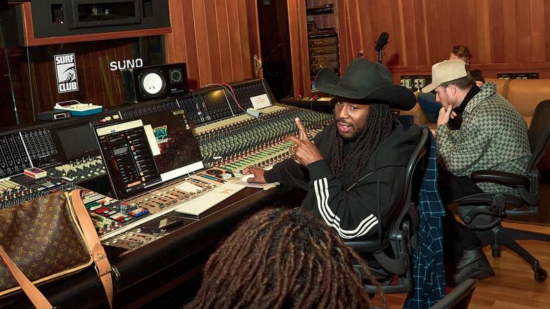 People making music in a studio using Suno
