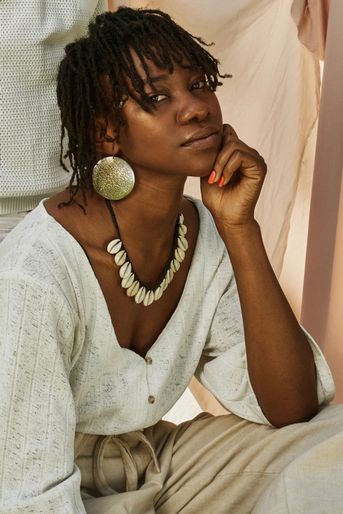 Young black woman staring into camera pensive