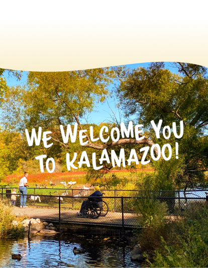 Accessible outdoor scene with a person in a wheelchair on a bridge, surrounded by trees, a pond, and birds, with two other people nearby. A text reads: 'We welcome you to Kalamazoo!'