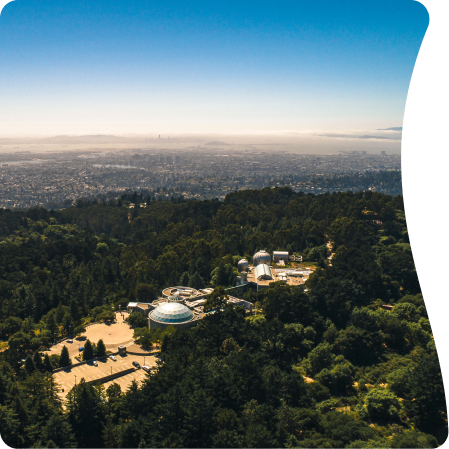 An aerial view of the Chabot Space & Science Center in Oakland, California, with the city of San Francisco in the background.