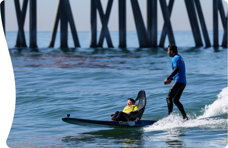 young boy taking surfing's class with an instructor