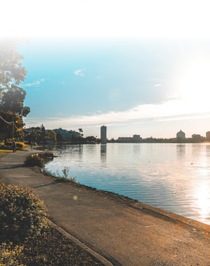 An Oakland landscape showing a lake and buildings at background