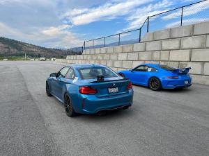 Blue cars sitting at race track