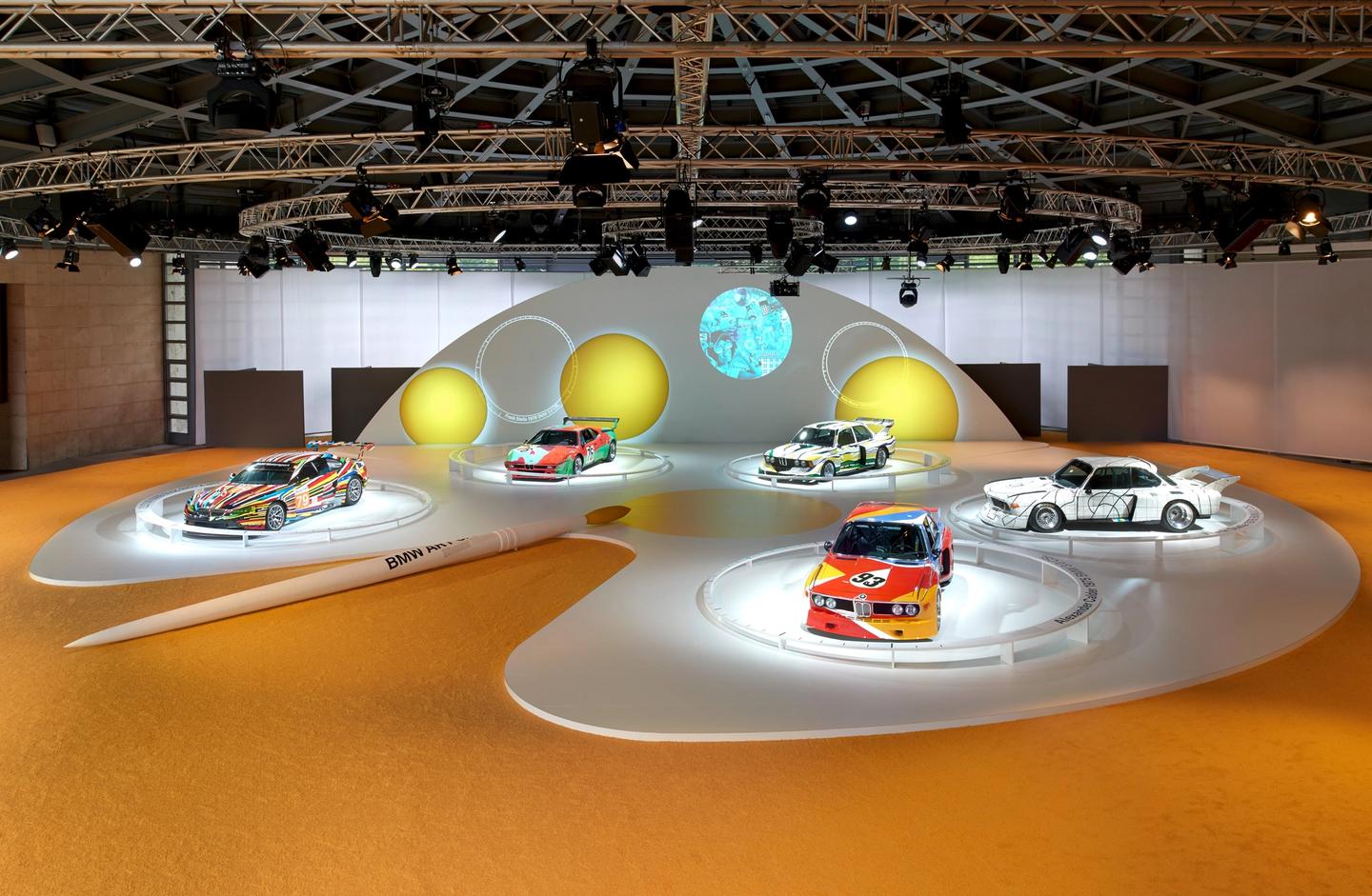 Group photo of five BMW Art Cars