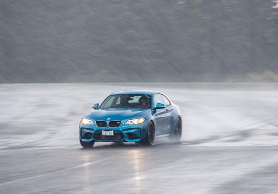 BMW M2 on a racetrack in the rain
