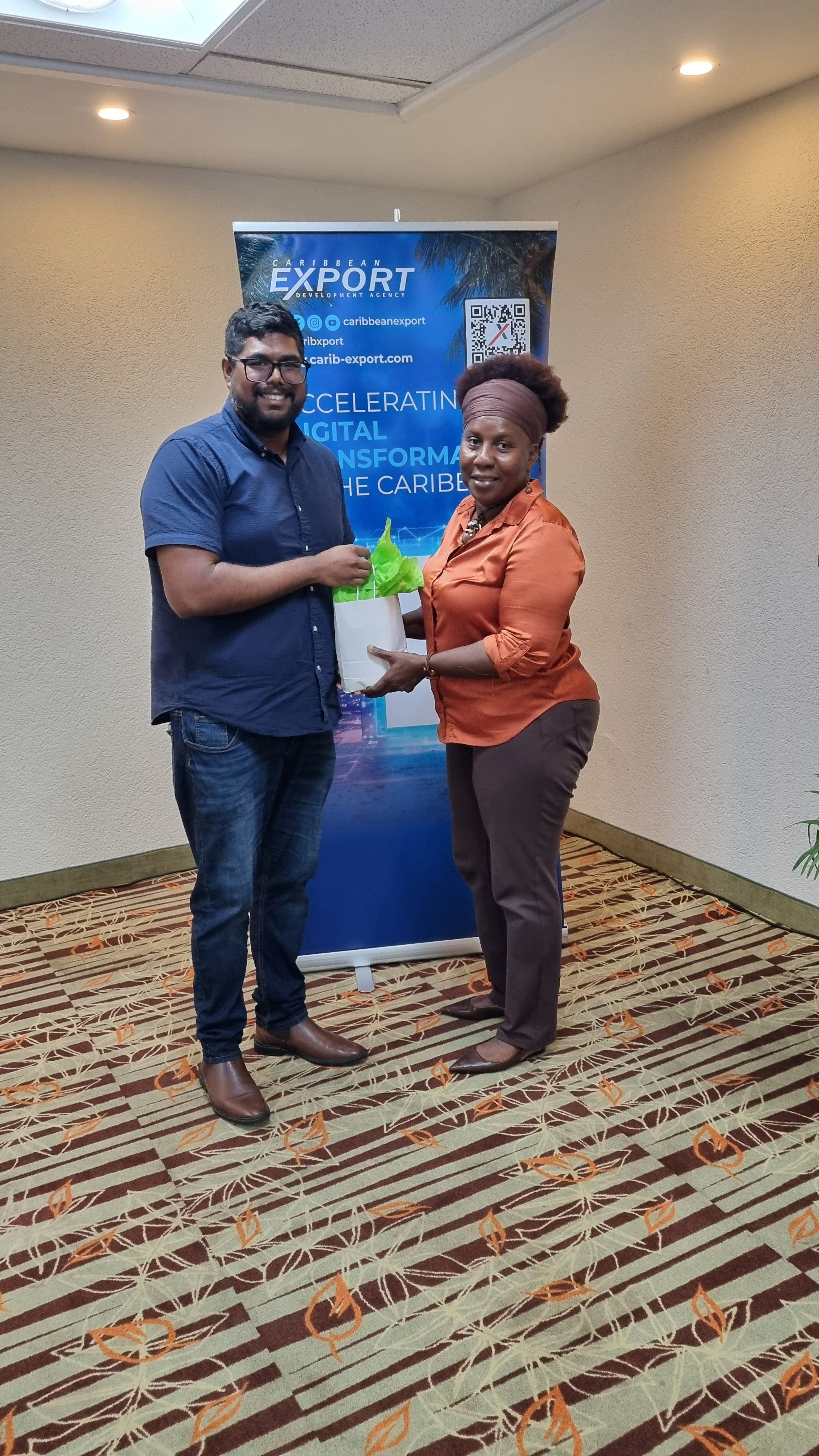 A photo of a participant presenting Caribbean Export's Jonathan Seecharan with a token of appreciation