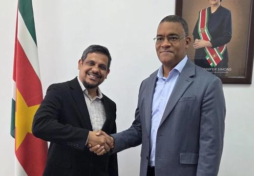 Dr Damie Sinanan greets the Honourable Andrew Baasaron