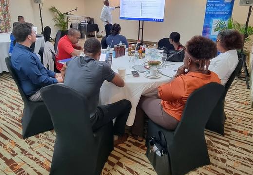 A photo of a cross-section of Digital Bootcamp participants listening to the Facilitator
