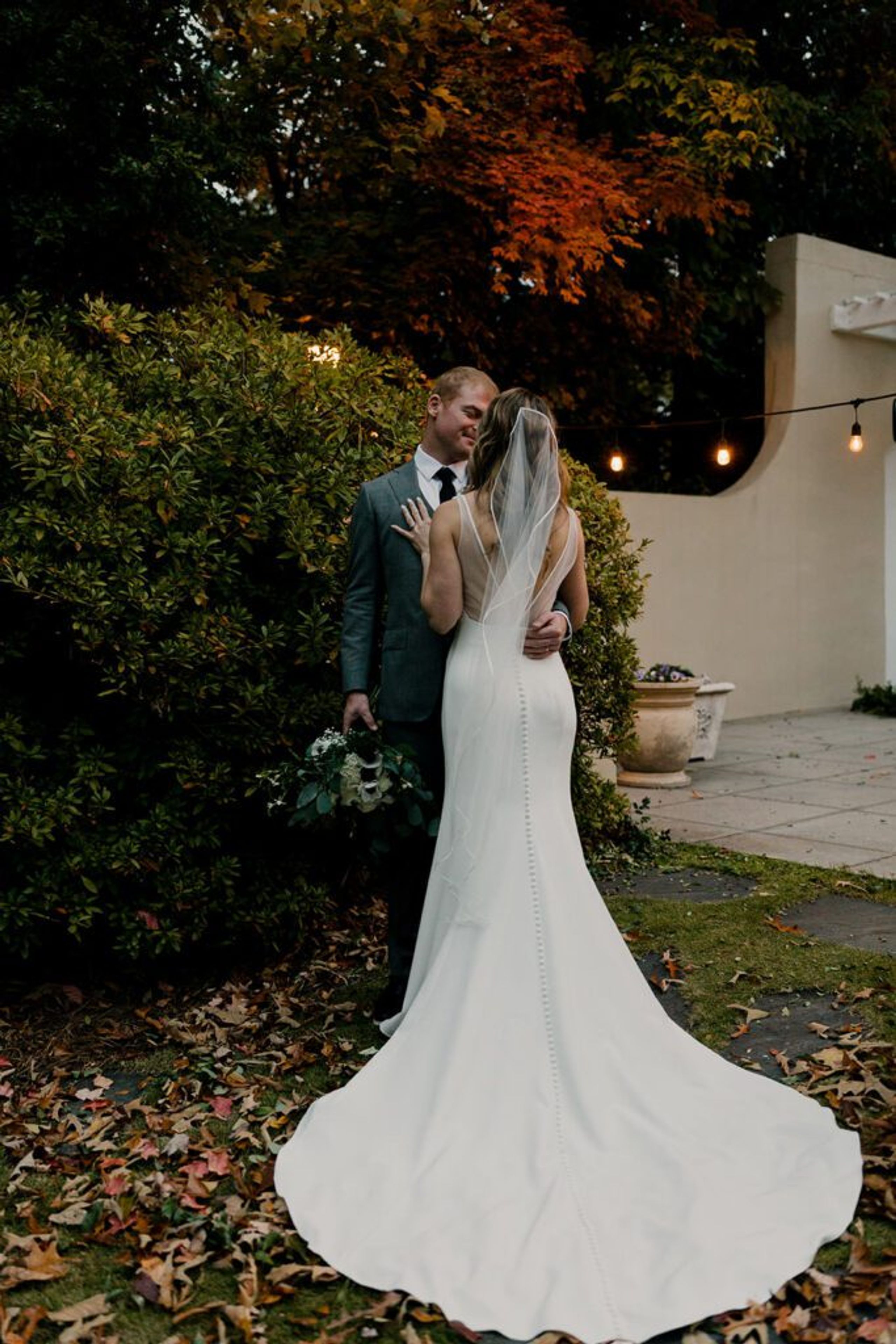 Scott and Deb share a tender embrace in the garden at 173 Carlyle House.