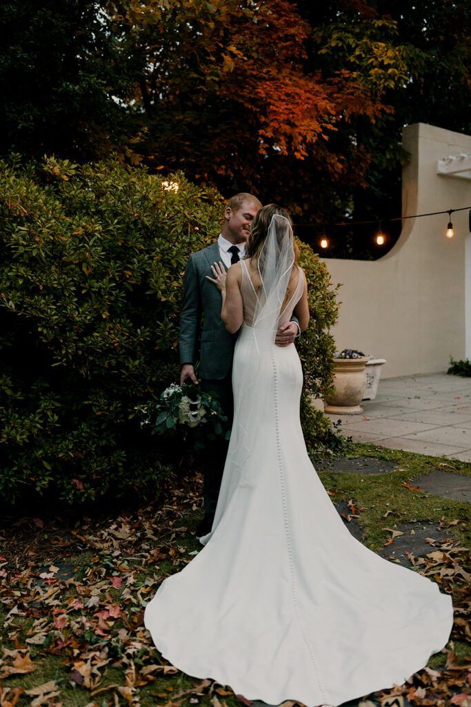Scott and Deb share a tender embrace in the garden at 173 Carlyle House.