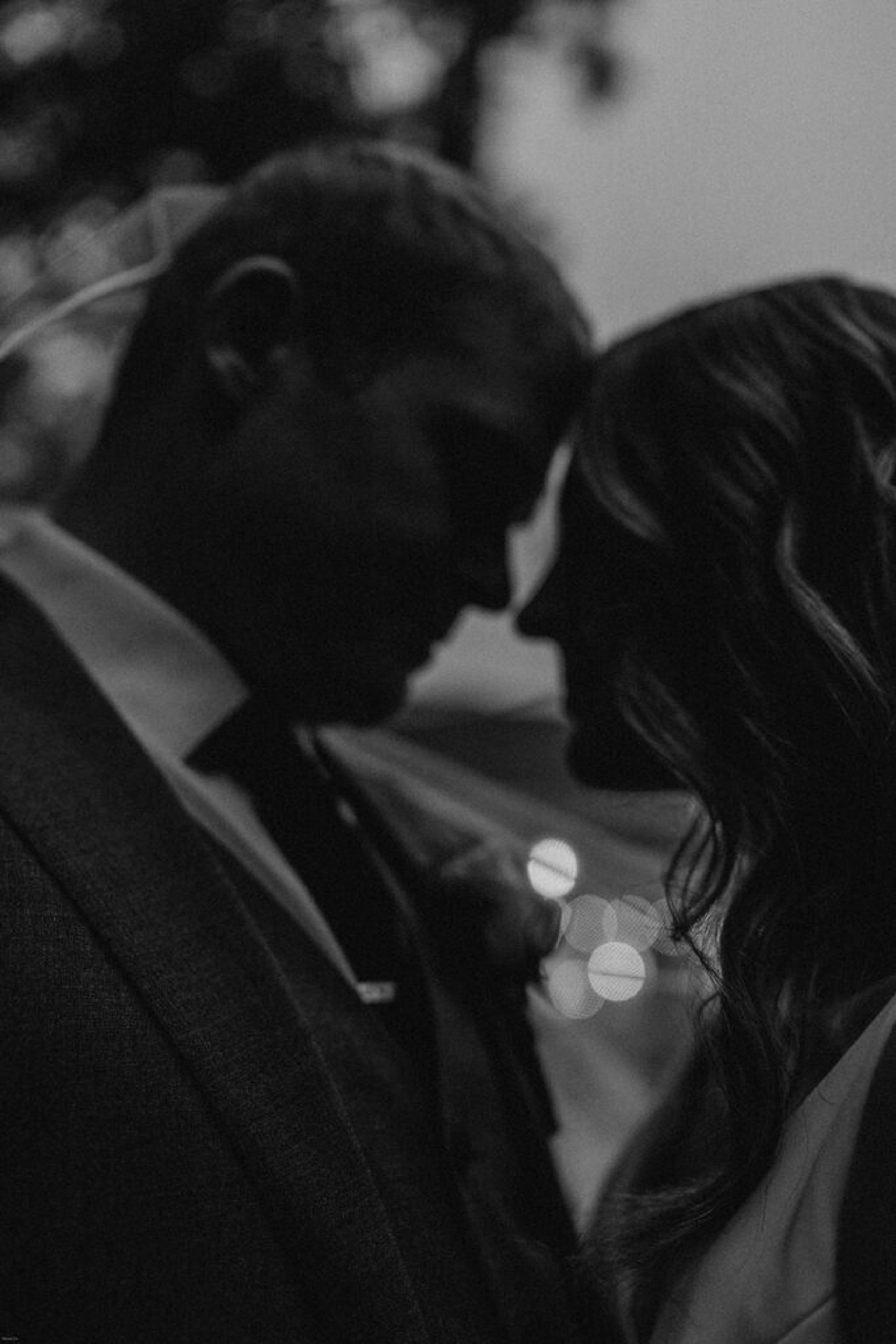 Scott and Deb share an intimate moment, with their foreheads touching, under the warm lights at 173 Carlyle House