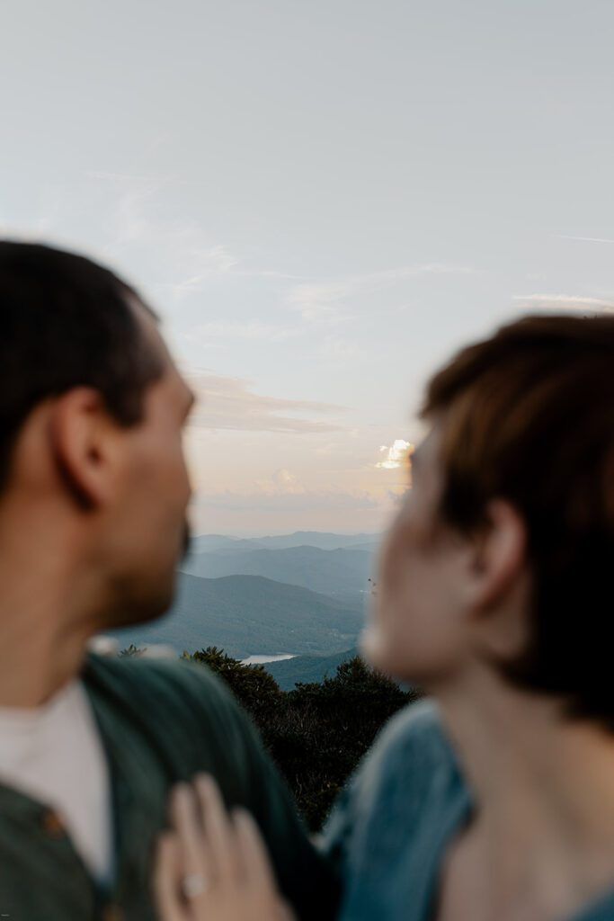 Couple looking out over the mountains during their Craggy Gardens engagement session.