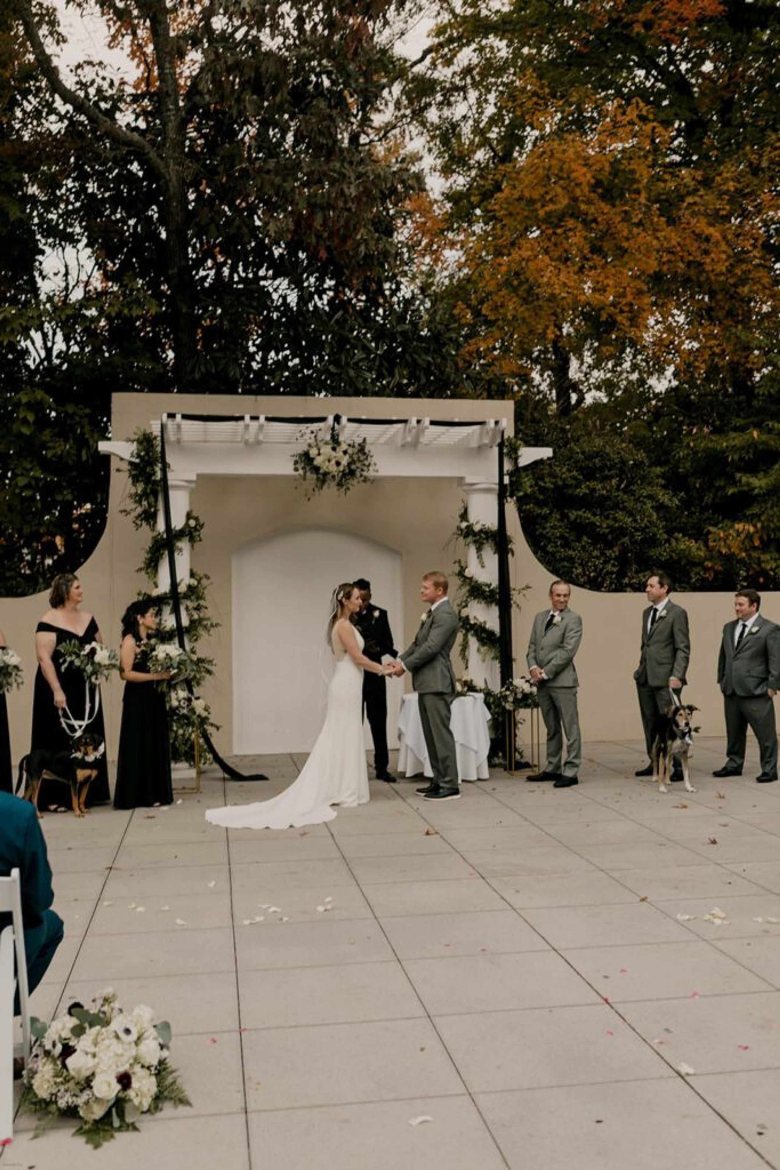 Scott and Deb exchange vows under a decorated arch at 173 Carlyle House, with guests watching