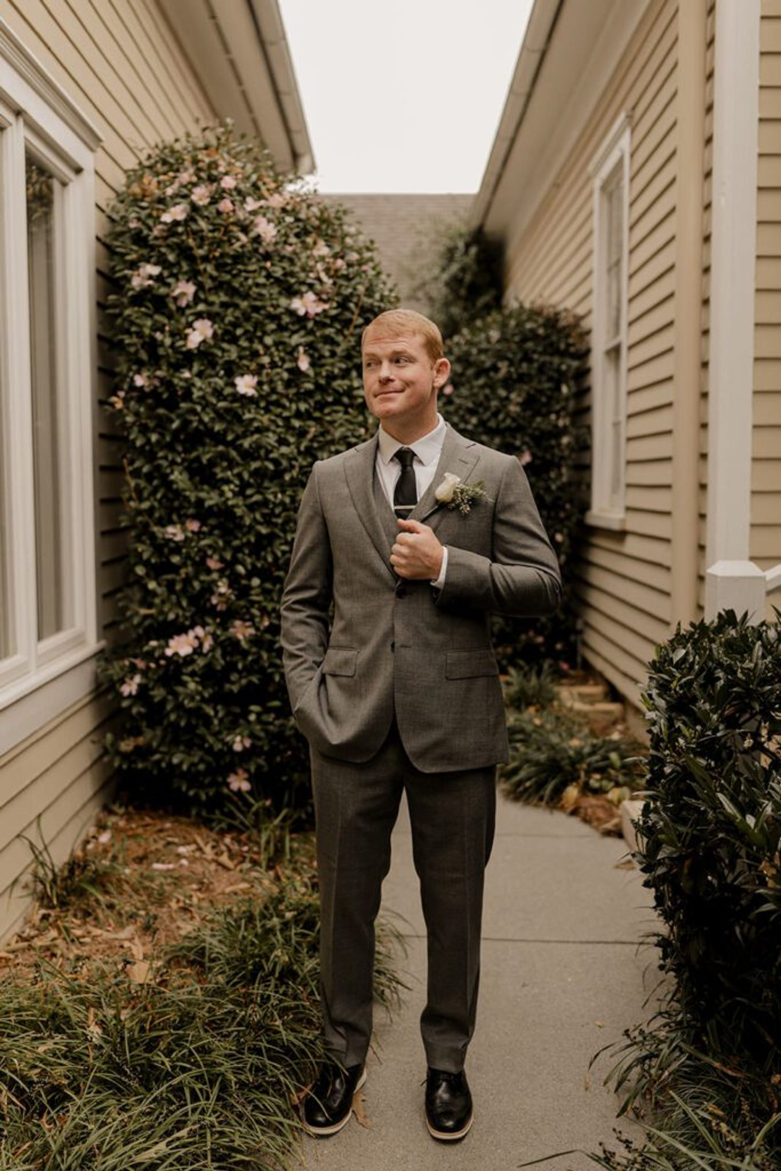 Scott stands alone, looking thoughtful before the ceremony at 173 Carlyle House.