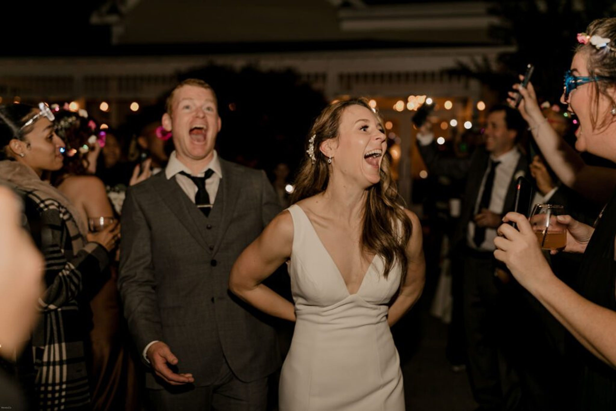 Scott and Deb celebrate with joyous expressions during their wedding reception at 173 Carlyle House, surrounded by friends and family.