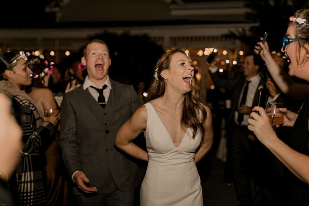 Scott and Deb celebrate with joyous expressions during their wedding reception at 173 Carlyle House, surrounded by friends and family.
