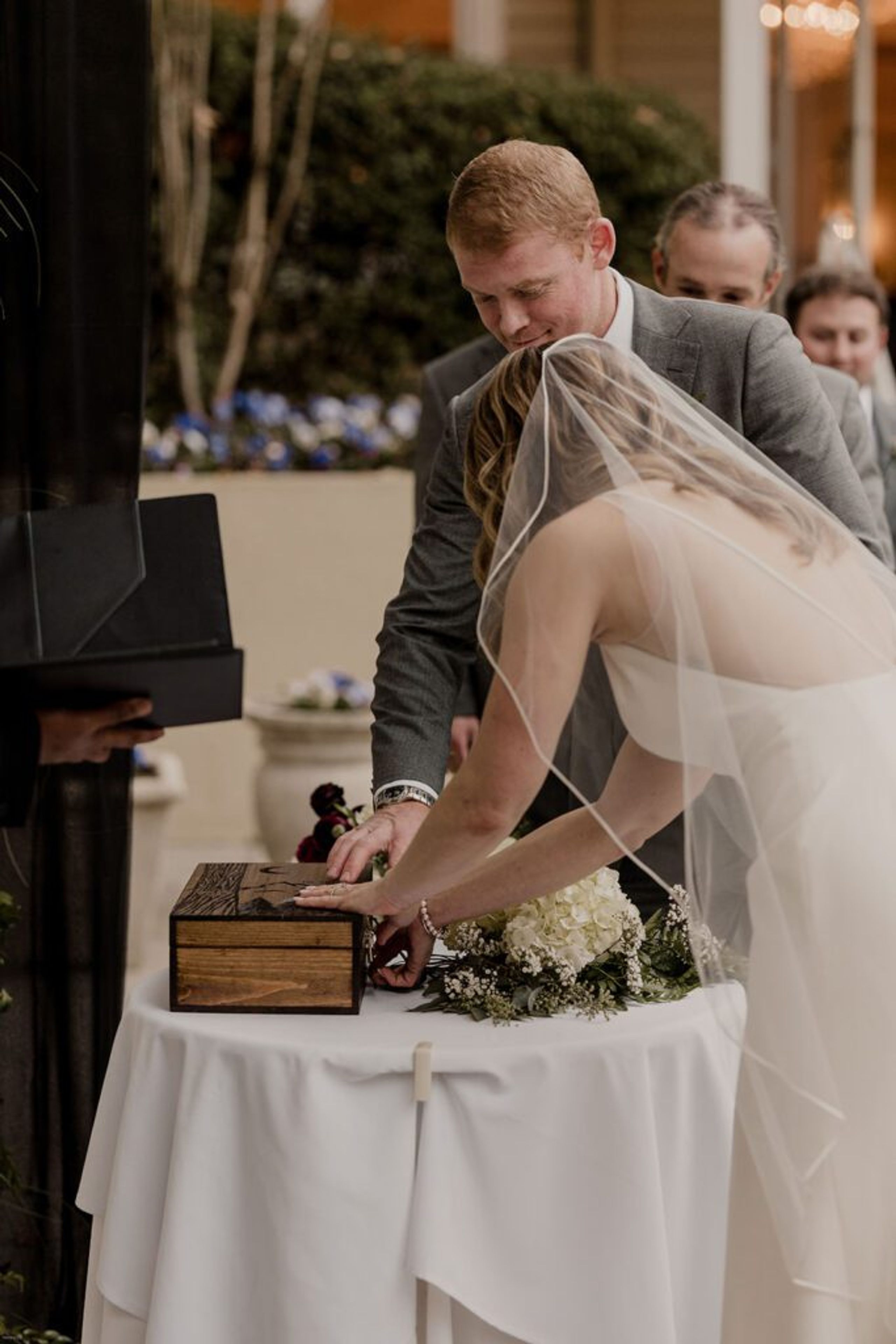 Deb and Scott participate in a unity ceremony, pouring sand into a shared container at 173 Carlyle House."