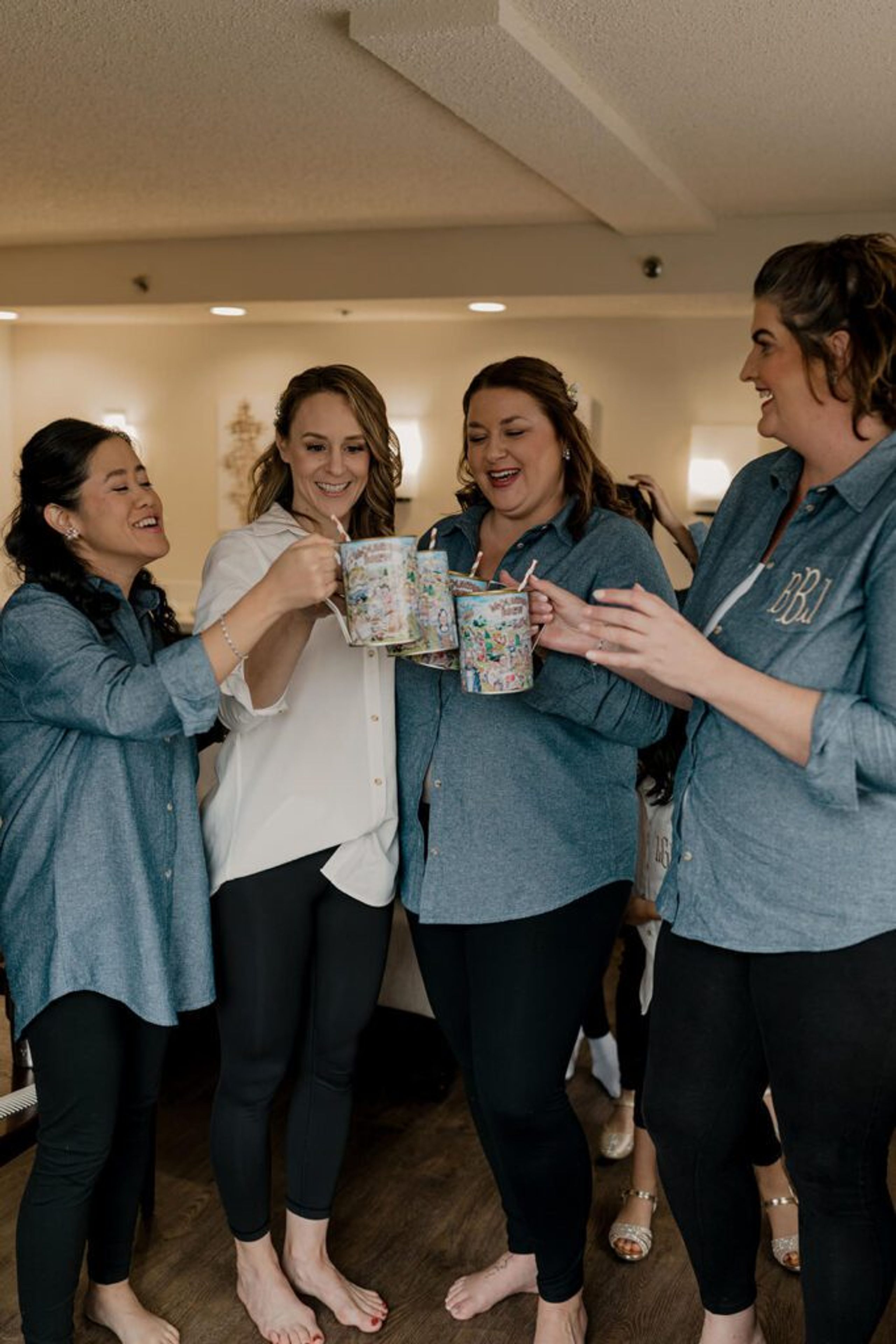 Deb and her bridesmaids raise their mugs in a toast at 173 Carlyle House, celebrating together before the ceremony
