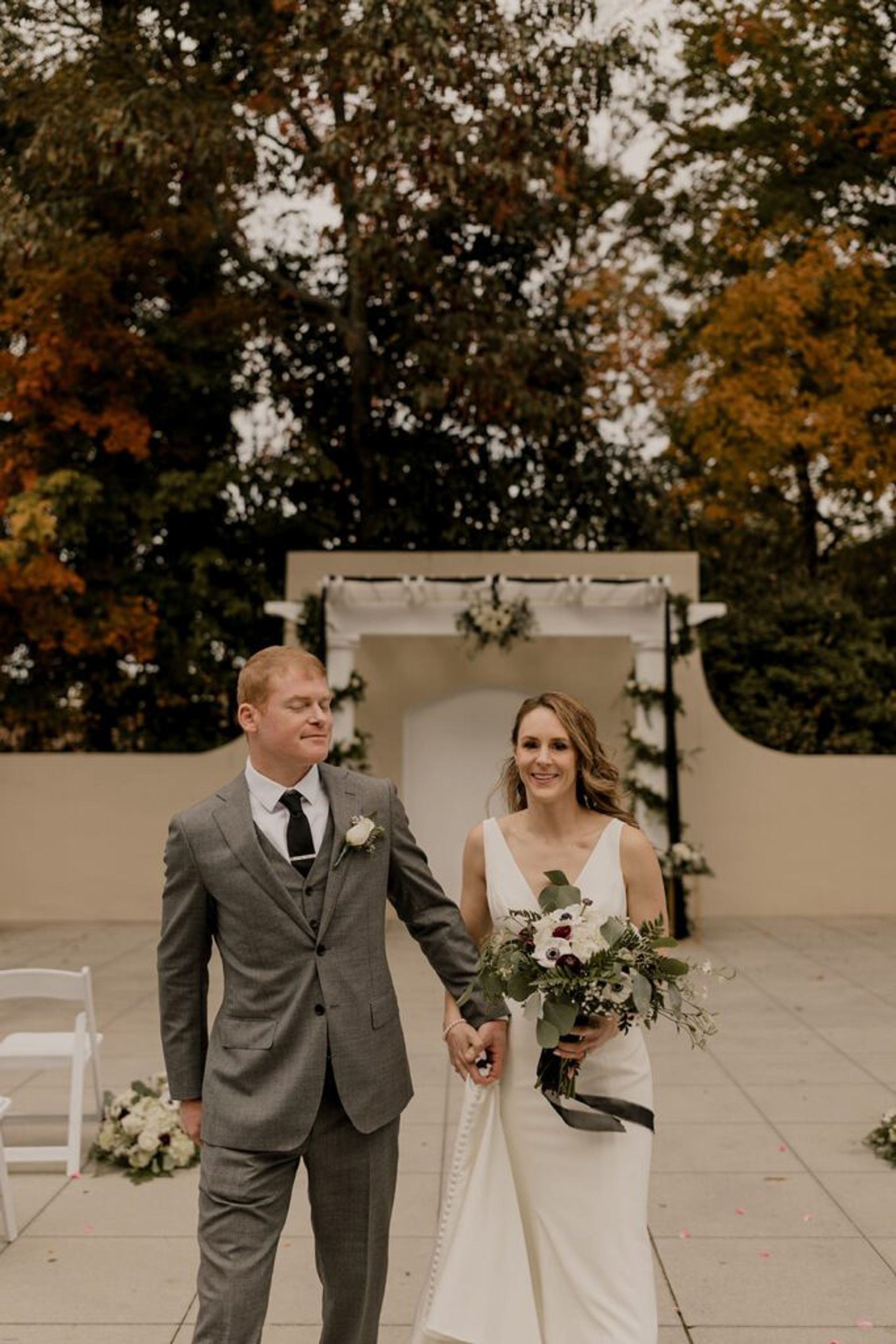 Scott and Deb walk hand in hand down the aisle after their ceremony at 173 Carlyle House.