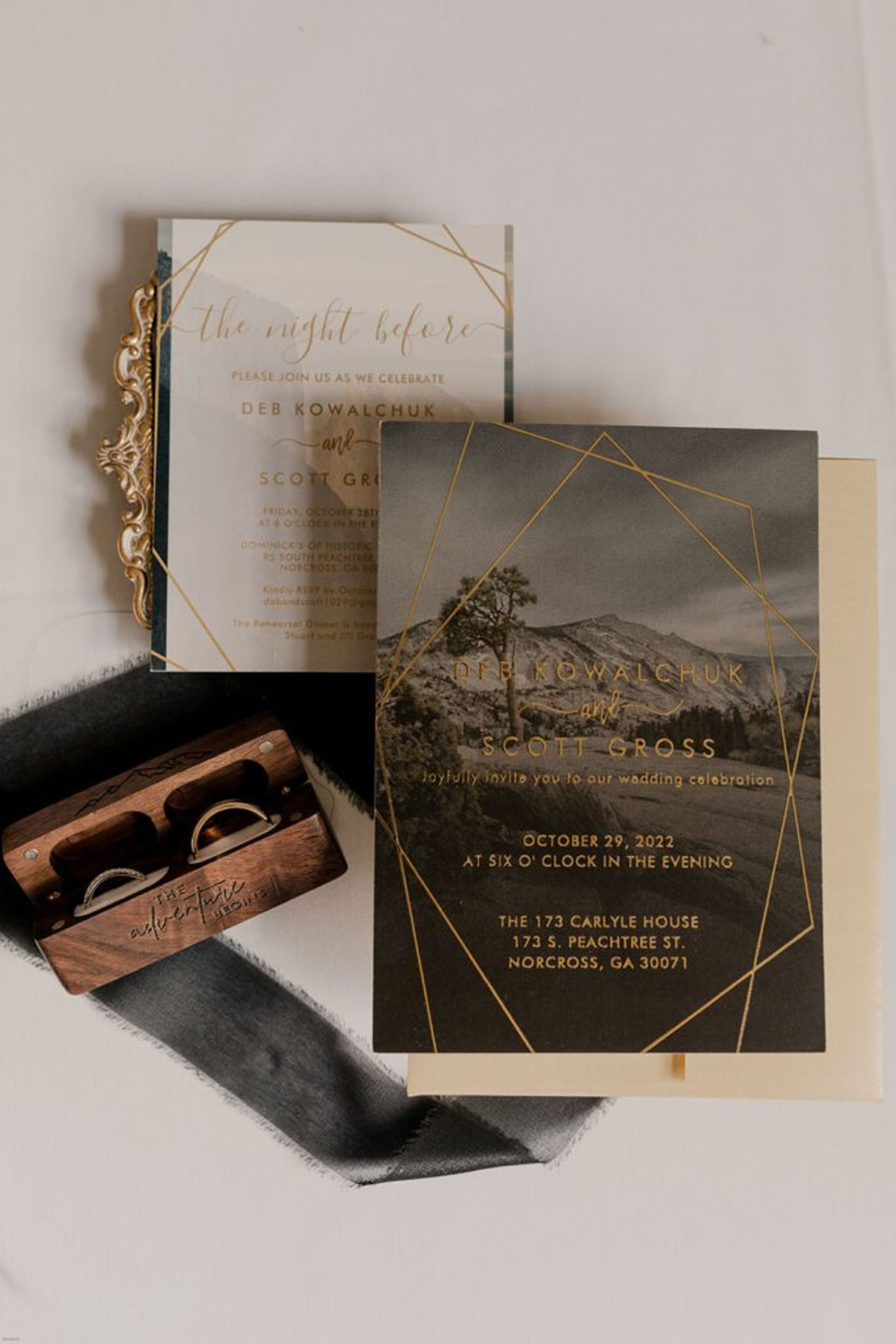 A close-up of wedding invitations and program details, arranged with delicate florals at 173 Carlyle House.