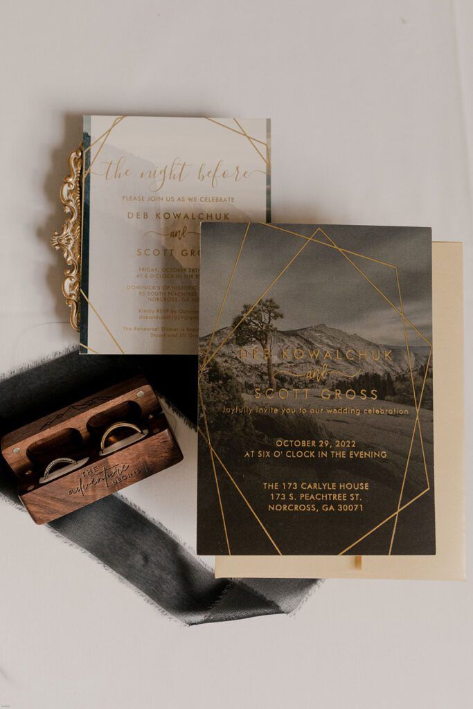 A close-up of wedding invitations and program details, arranged with delicate florals at 173 Carlyle House.