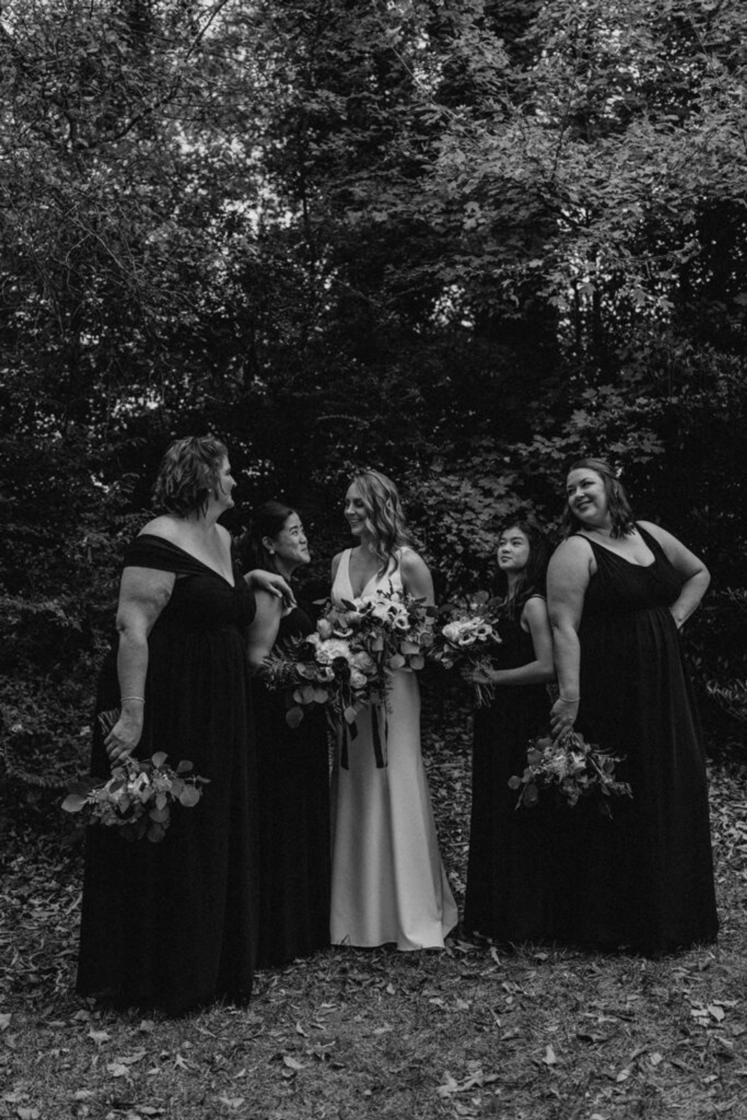 eb and her bridesmaids share a joyful moment together in the garden at 173 Carlyle House.