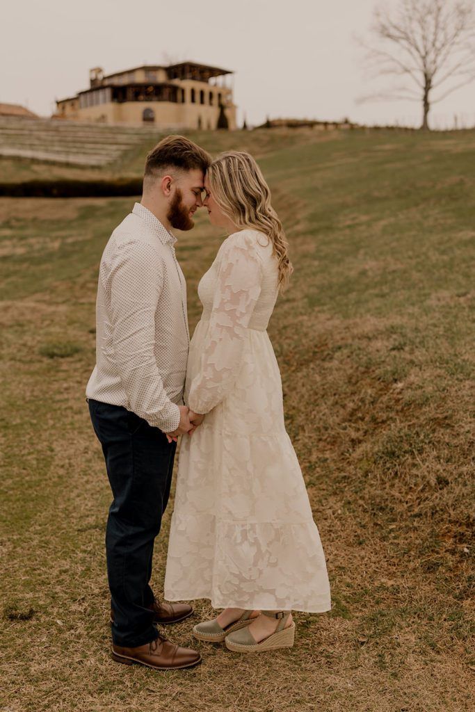 Taylor and Guillermo standing close together on the hill at Monteluce Winery, capturing a romantic moment.