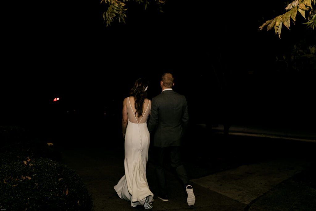 Scott and Deb walk away together under the night sky after their wedding celebration at 173 Carlyle House.