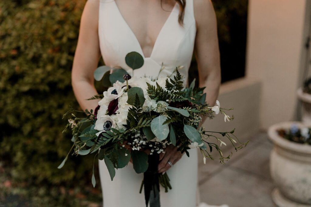 A close-up of Deb’s bouquet and wedding dress, capturing the elegant details at 173 Carlyle House.