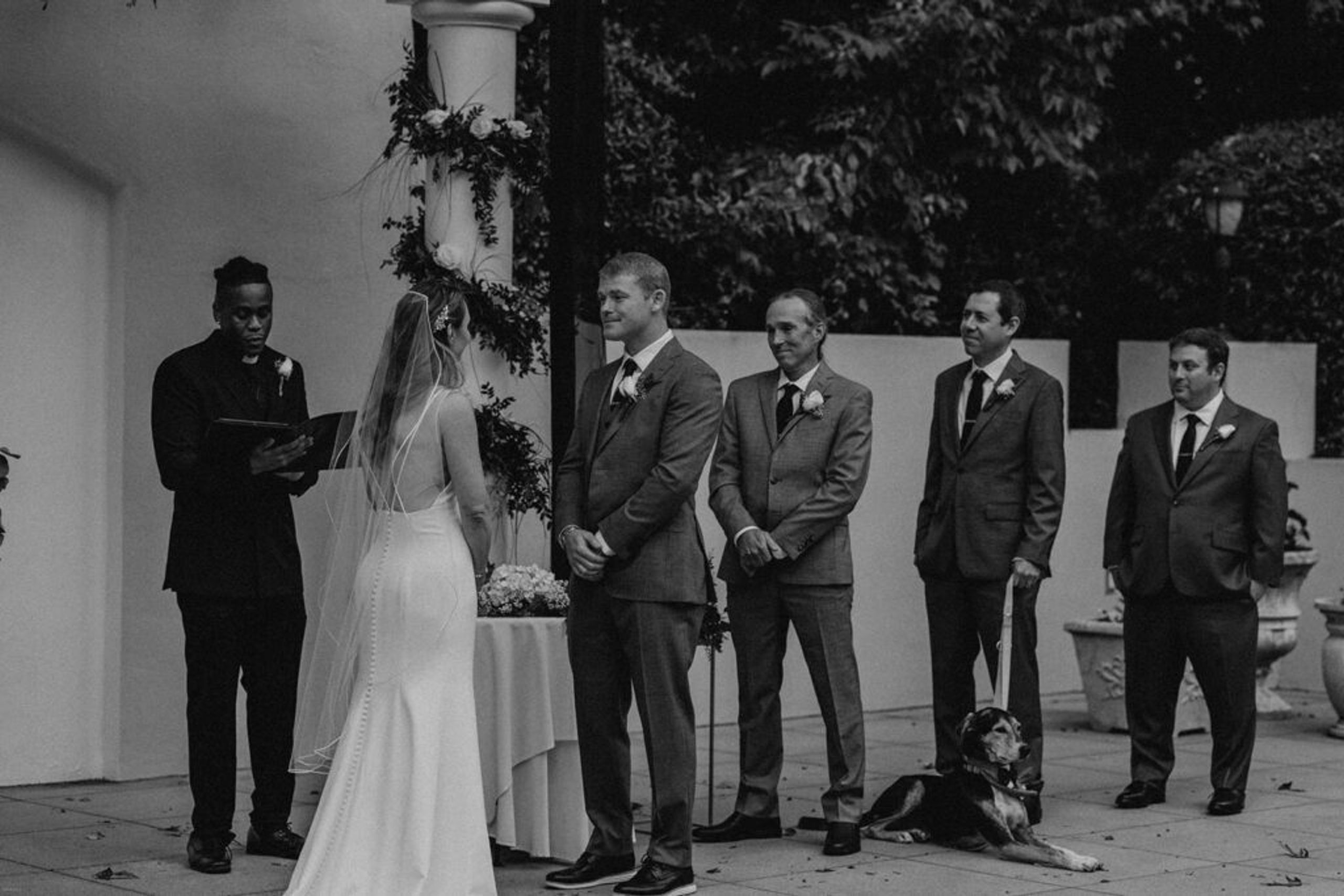 Scott and Deb stand at the altar, ready to exchange their vows in a beautifully decorated outdoor space at 173 Carlyle House.