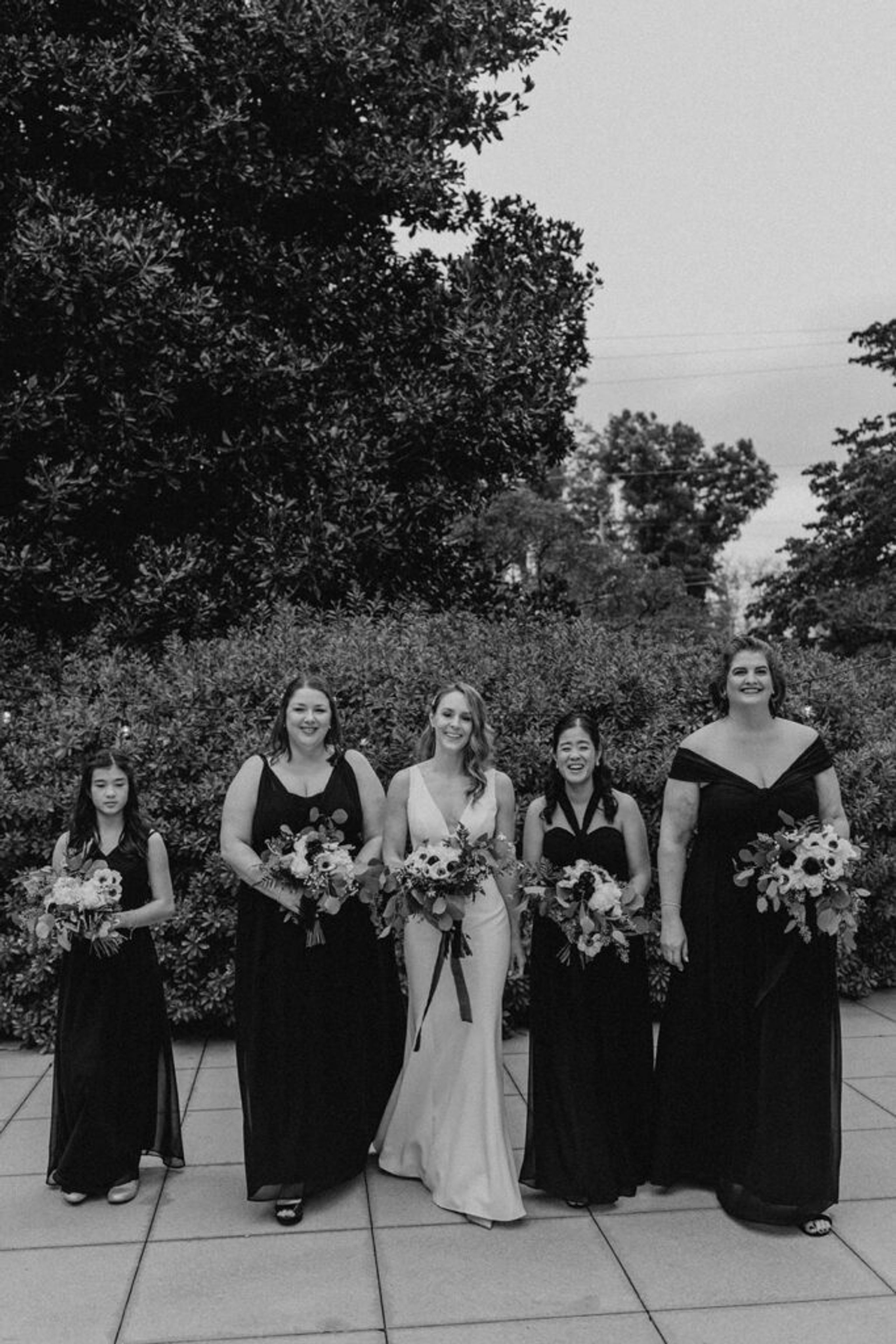 A black-and-white shot of Deb with her bridesmaids, all standing together at 173 Carlyle House.