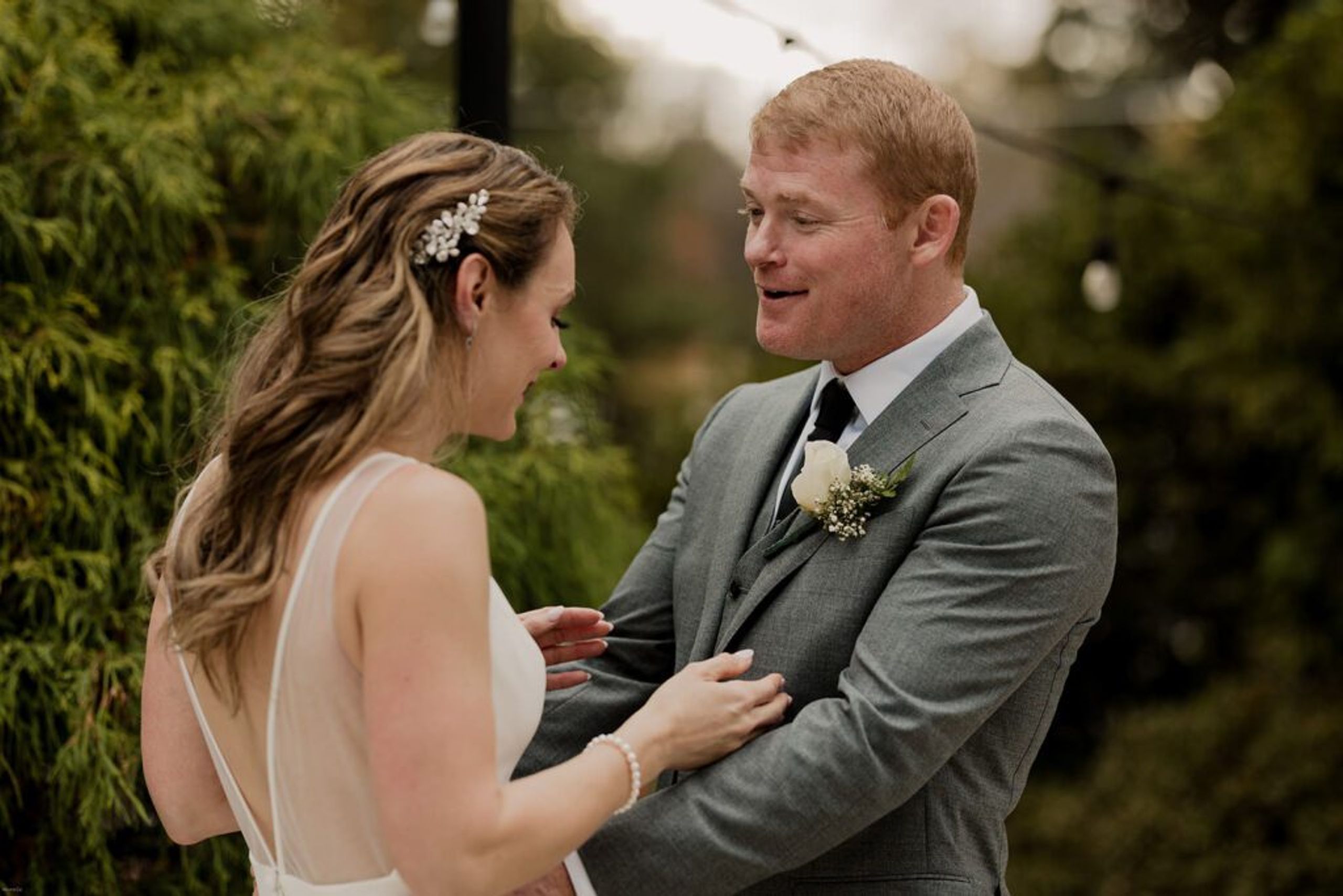 Deb and Scott share a joyful moment, smiling at each other during their wedding ceremony.