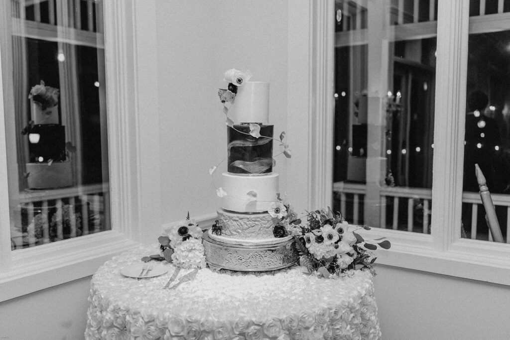 A three-tiered wedding cake displayed elegantly at the reception at 173 Carlyle House.
