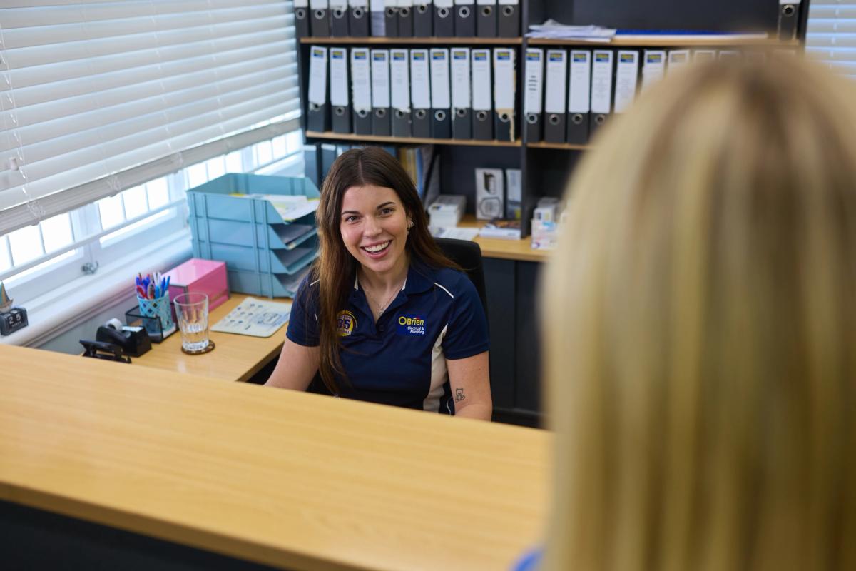 A team member greeting a customer at the branch front desk