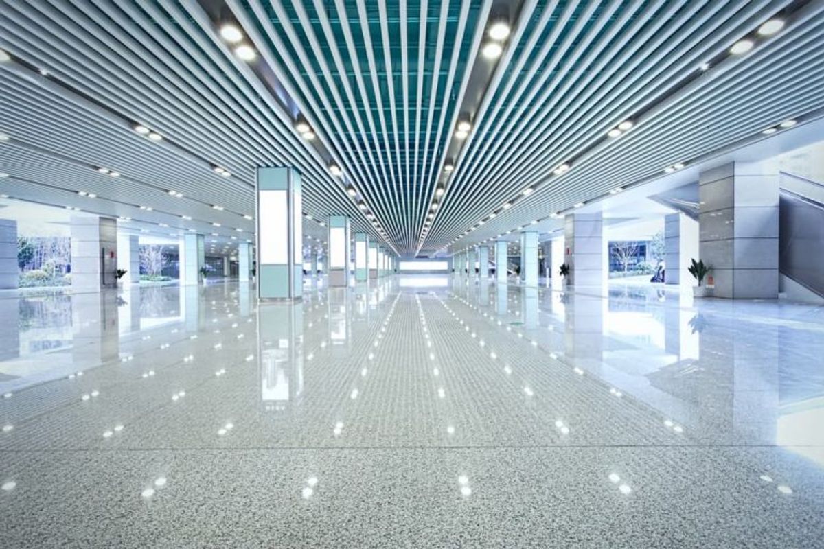 Linear lighting running the length of a bright commercial corridor