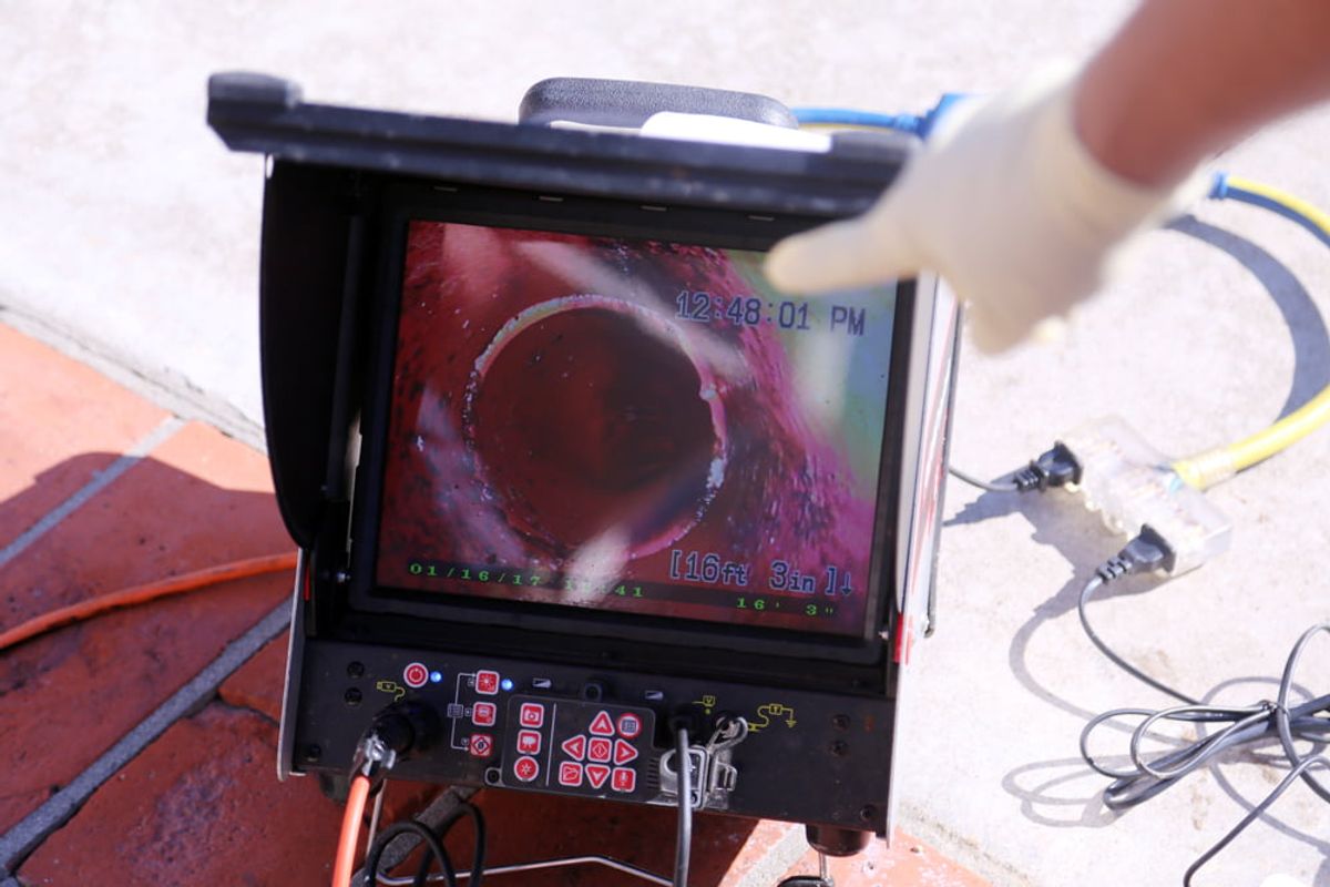 A CCTV drain camera monitor showing the inside of a pipe during an inspection