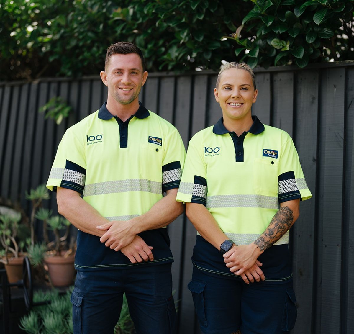 Two O’Brien tradespeople standing together outside a property