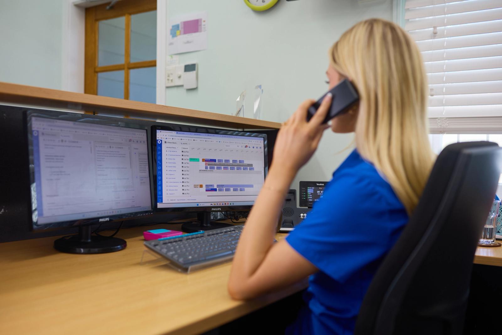 A team member taking a call at the Coopers Plains branch office