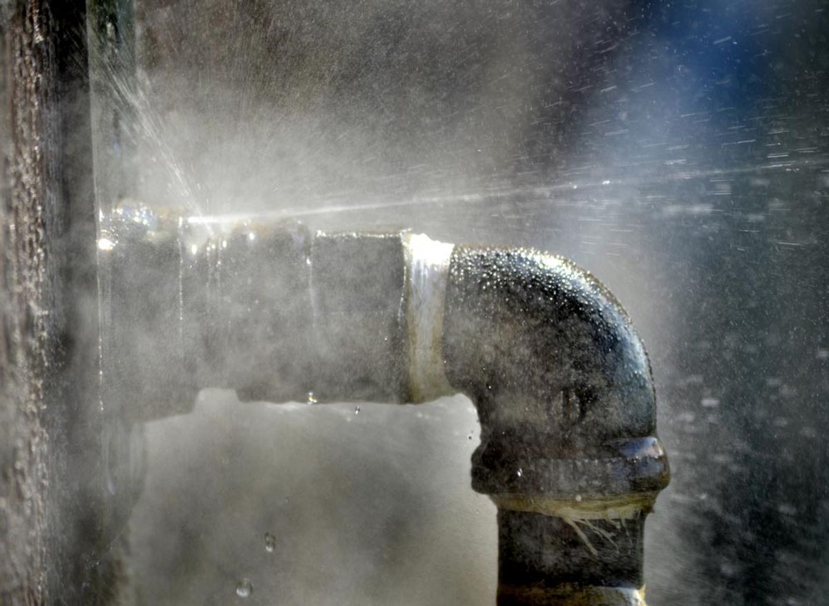 Water spraying from the joint of a corroded pipe