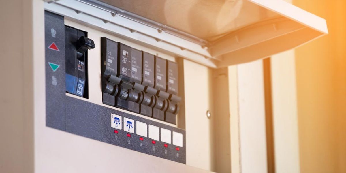 An open switchboard showing a row of circuit breakers