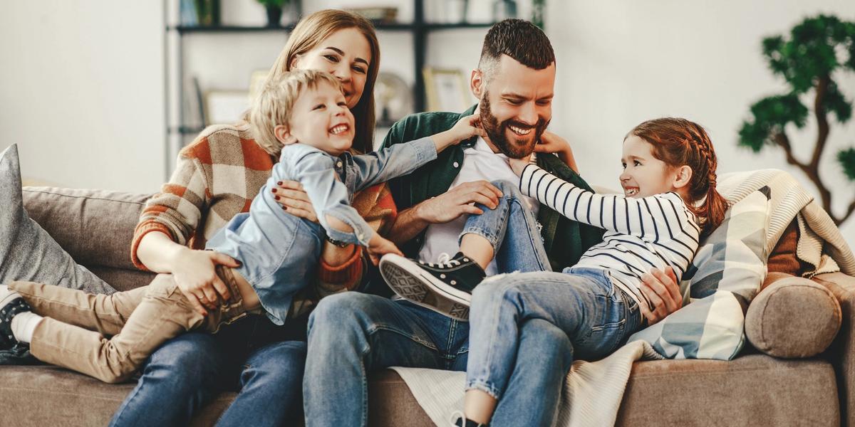 A family relaxing together on a sofa at home